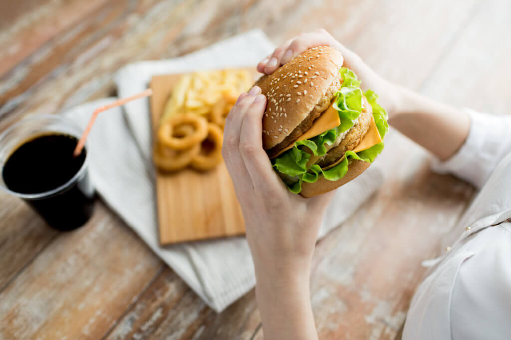 woman holding burger