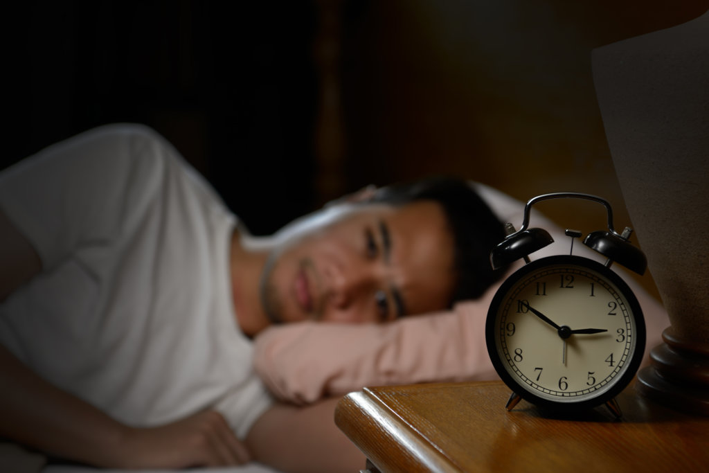 man struggling to sleep