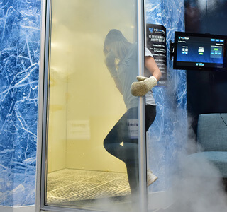 woman entering a whole body cryotherapy chamber