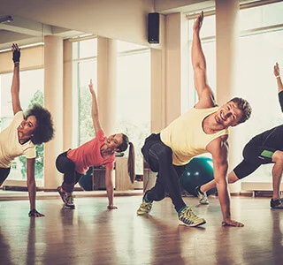 Group of young athlete people doing exercise together in fitness