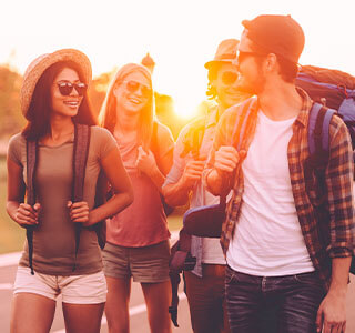 four friends laugh and walk together