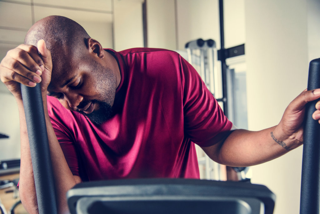 man tired on a workout machine