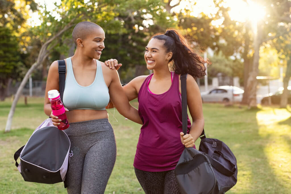 two friends smiling after a workout