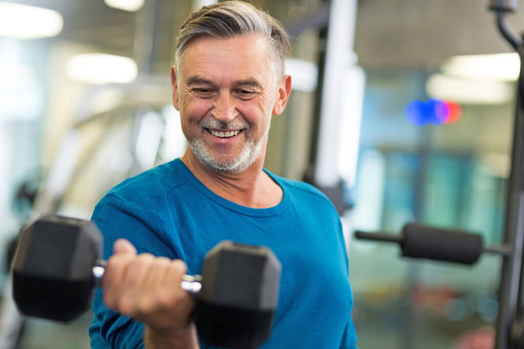 man doing a bicep curl in the gym