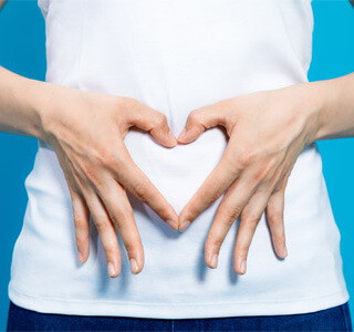 woman putting a heart over her stomach