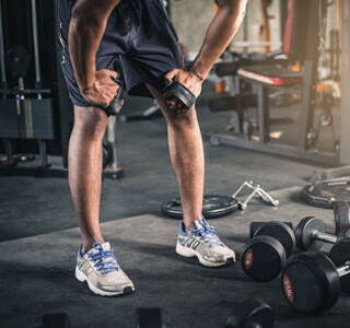 man bends over weights