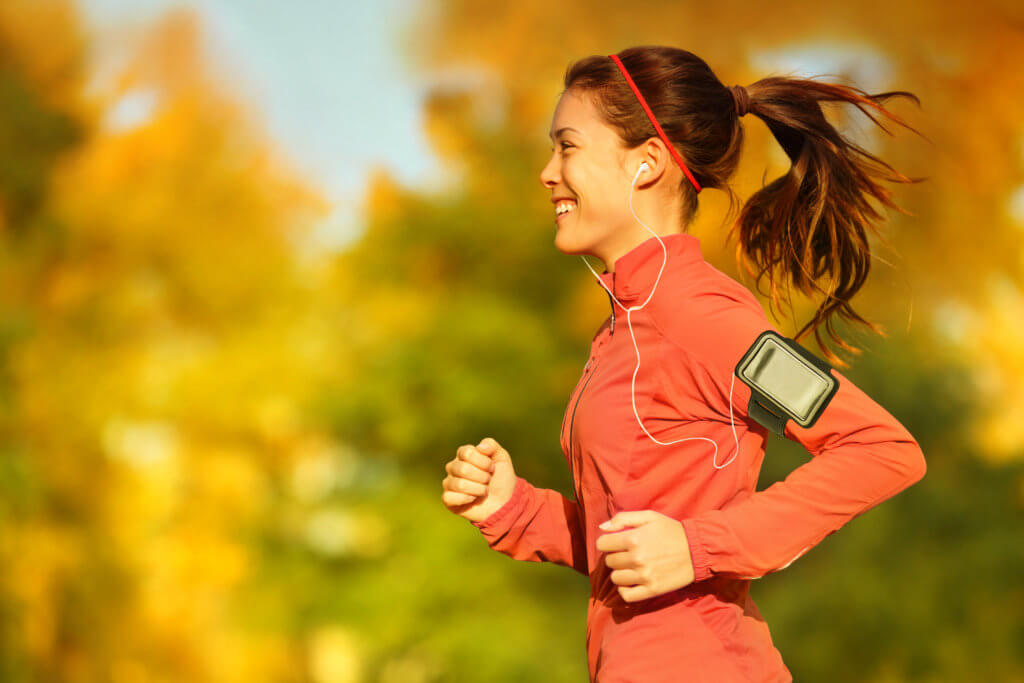 woman runs outdoors in the fall
