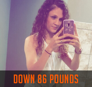 woman poses in mirror after weight loss