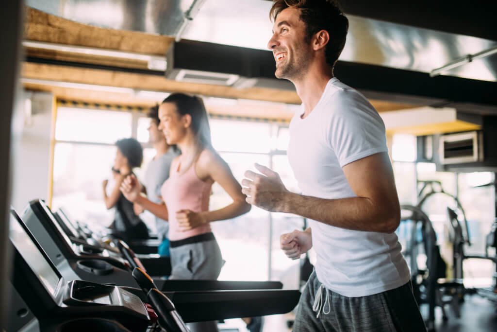 men and women run on treadmills
