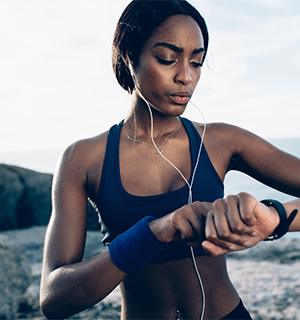 woman listening to music and checking watch