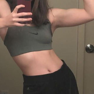 mirror selfie of woman showing off abs