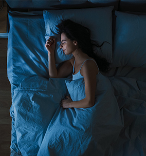 top view of woman sleeping in bed