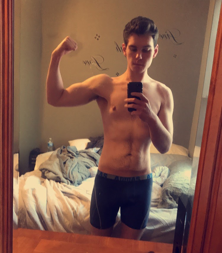 man flexing in mirror selfie