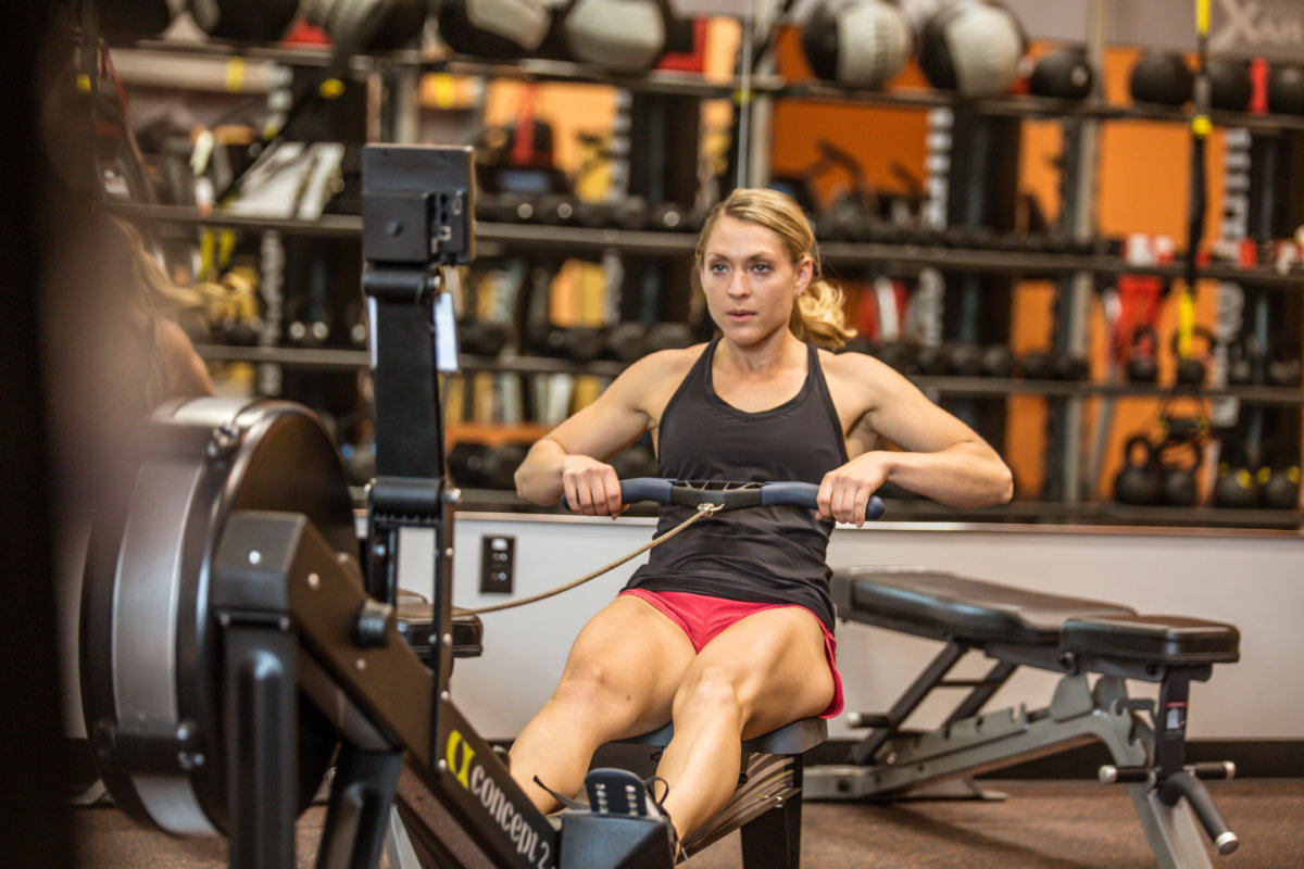 woman sitting in gym working out