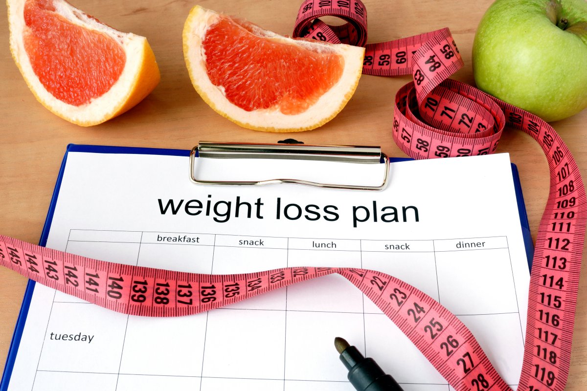 weight loss plan, measuring tape, fruits, pen