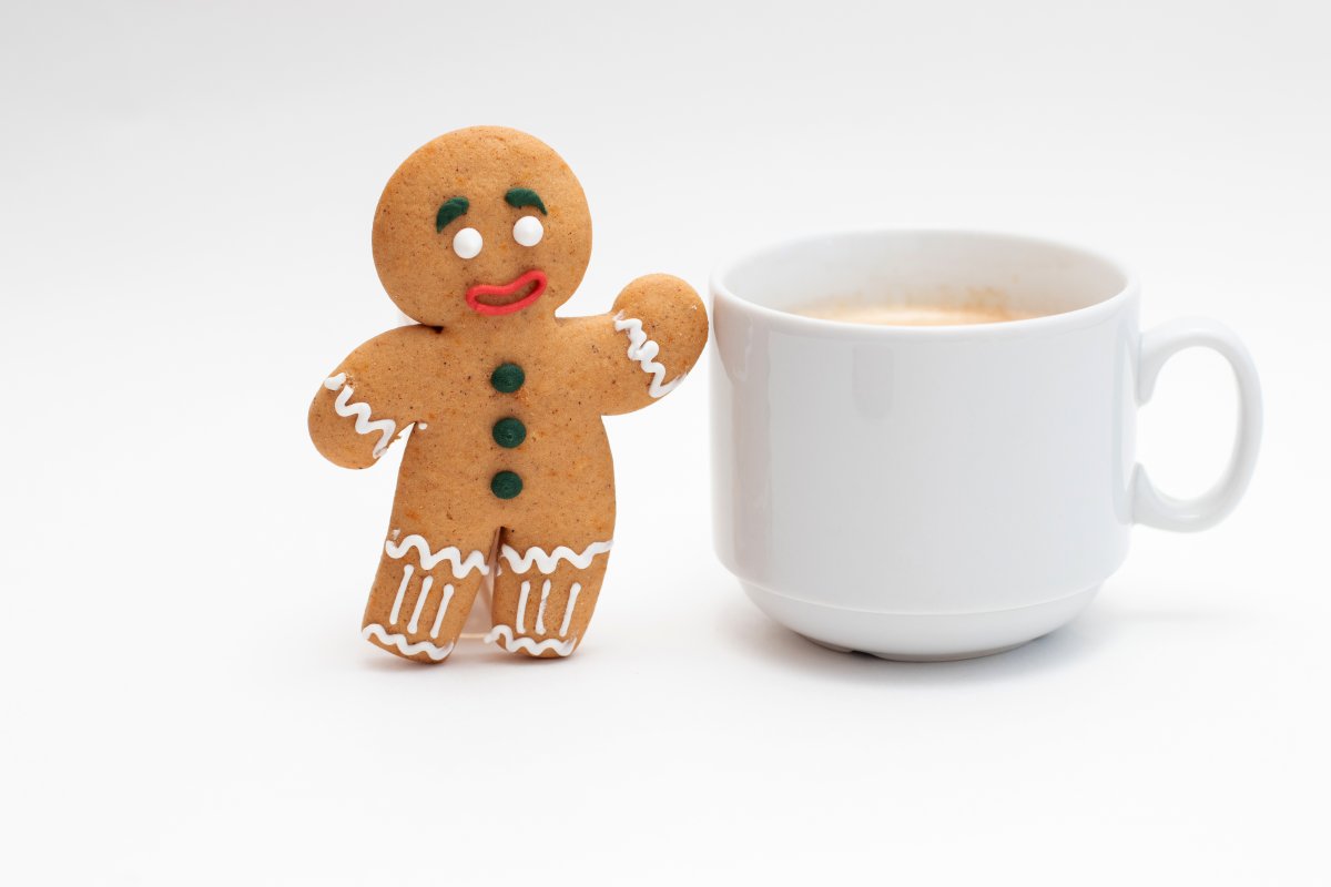 gingerbread man waving next to cup